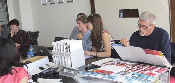 Tony reviewing fabric samples with clients at a worktable