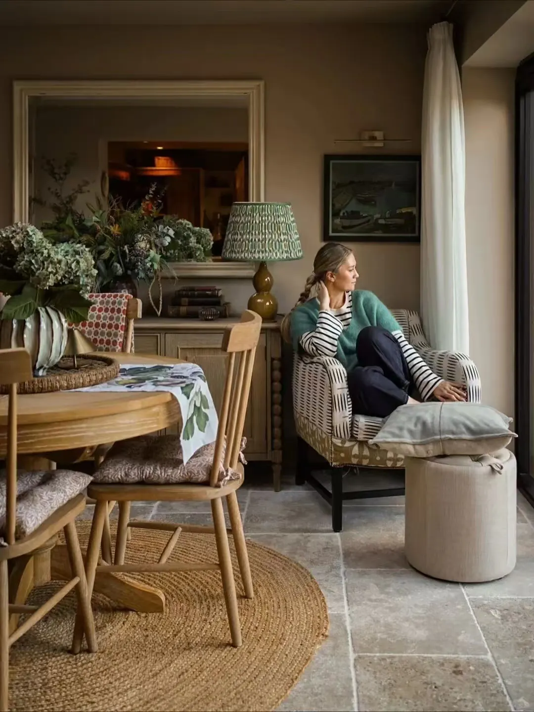 Full-length sheer curtains within a quietly furnished living room