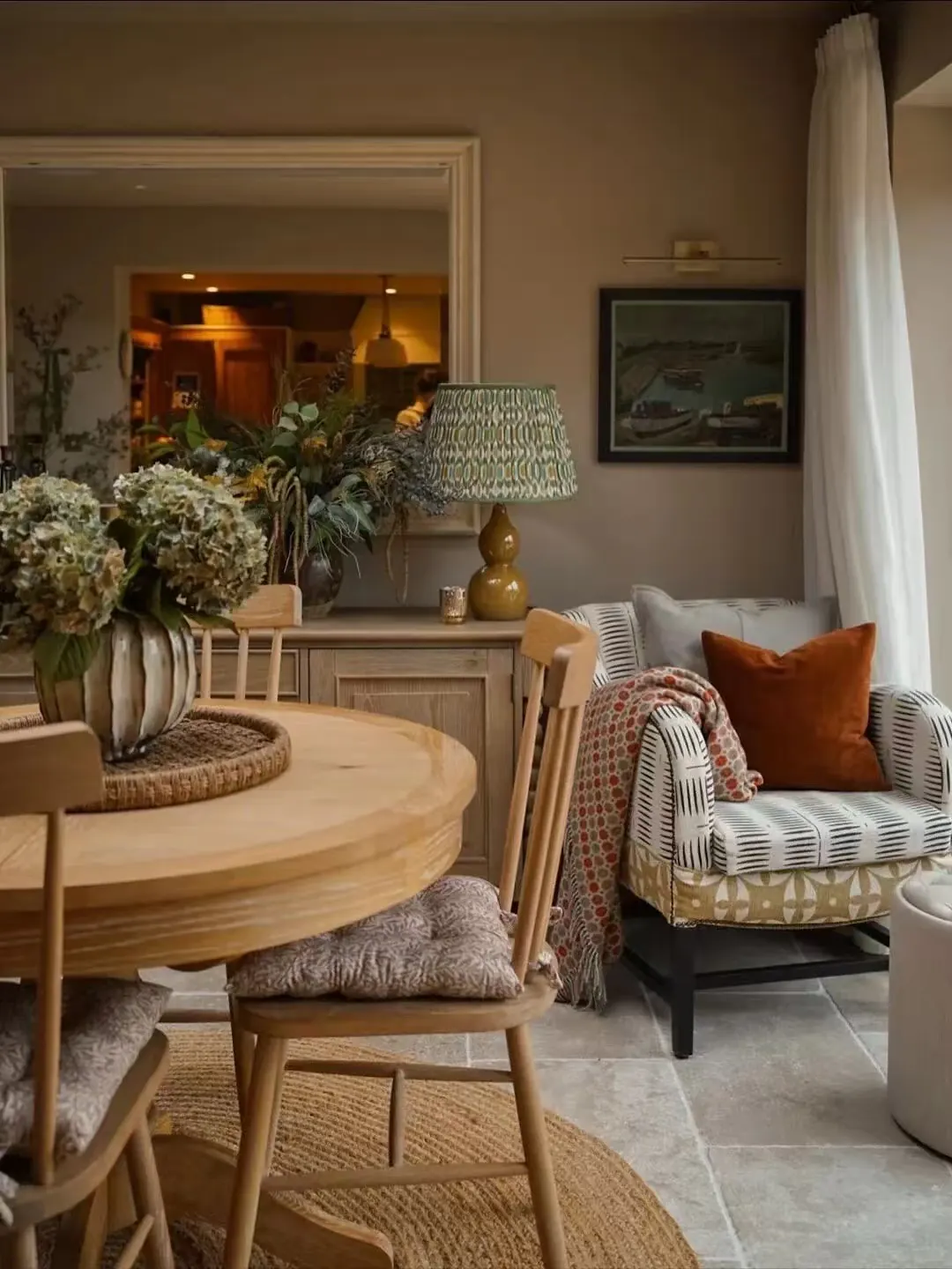 Layered curtains coordinated across an open-plan living room