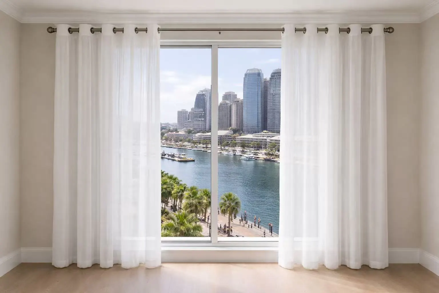 Soft neutral curtains filtering daylight across a wide apartment window