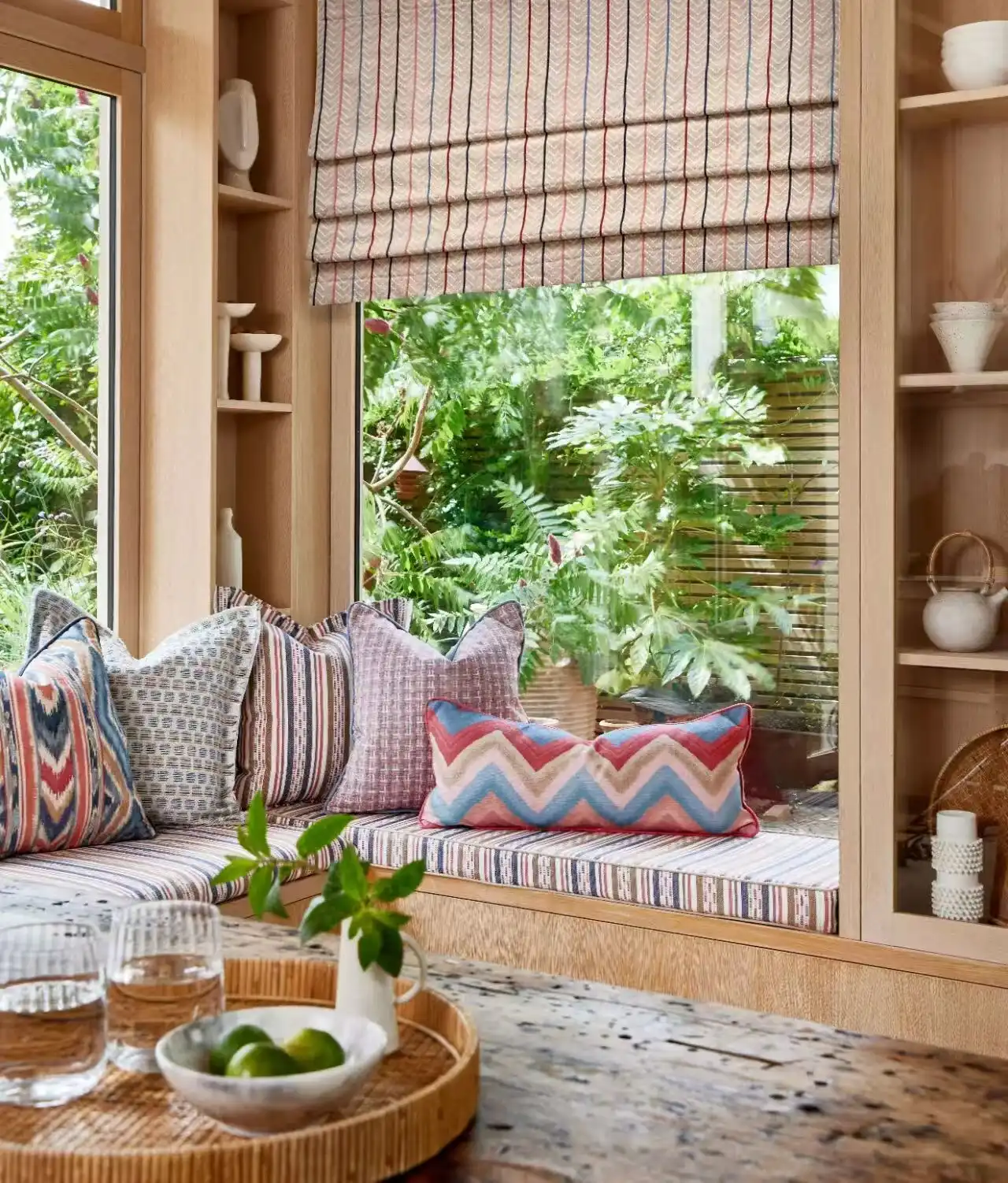 Patterned fabric Roman blind above a relaxed built-in window seat