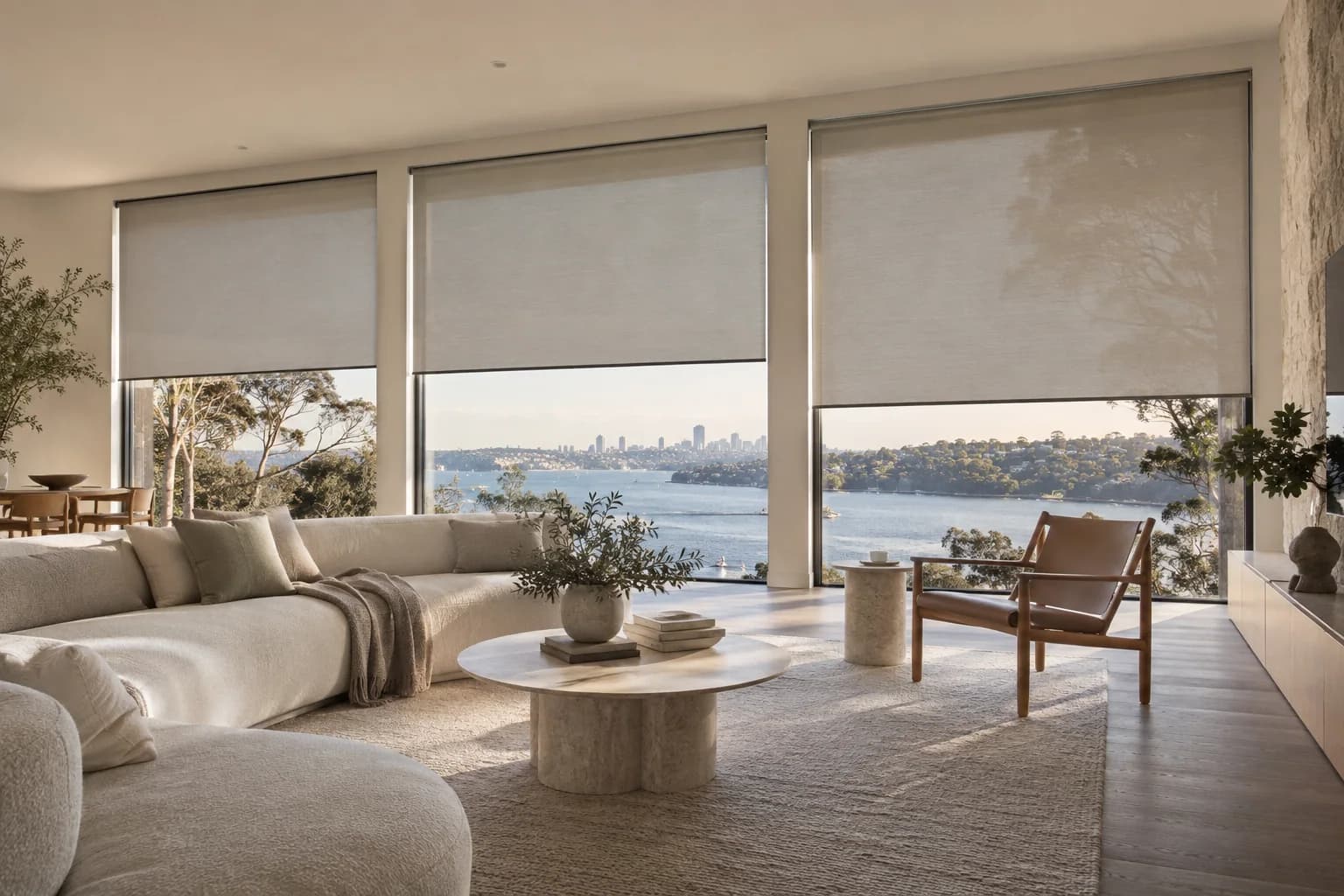 Custom roller blinds aligned across large living-room glazing