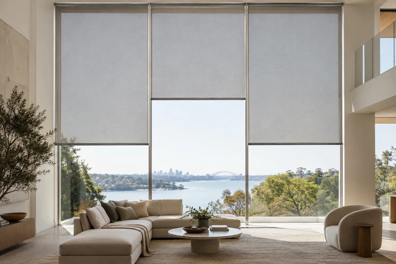 Aligned motorised roller blinds across tall residential glazing