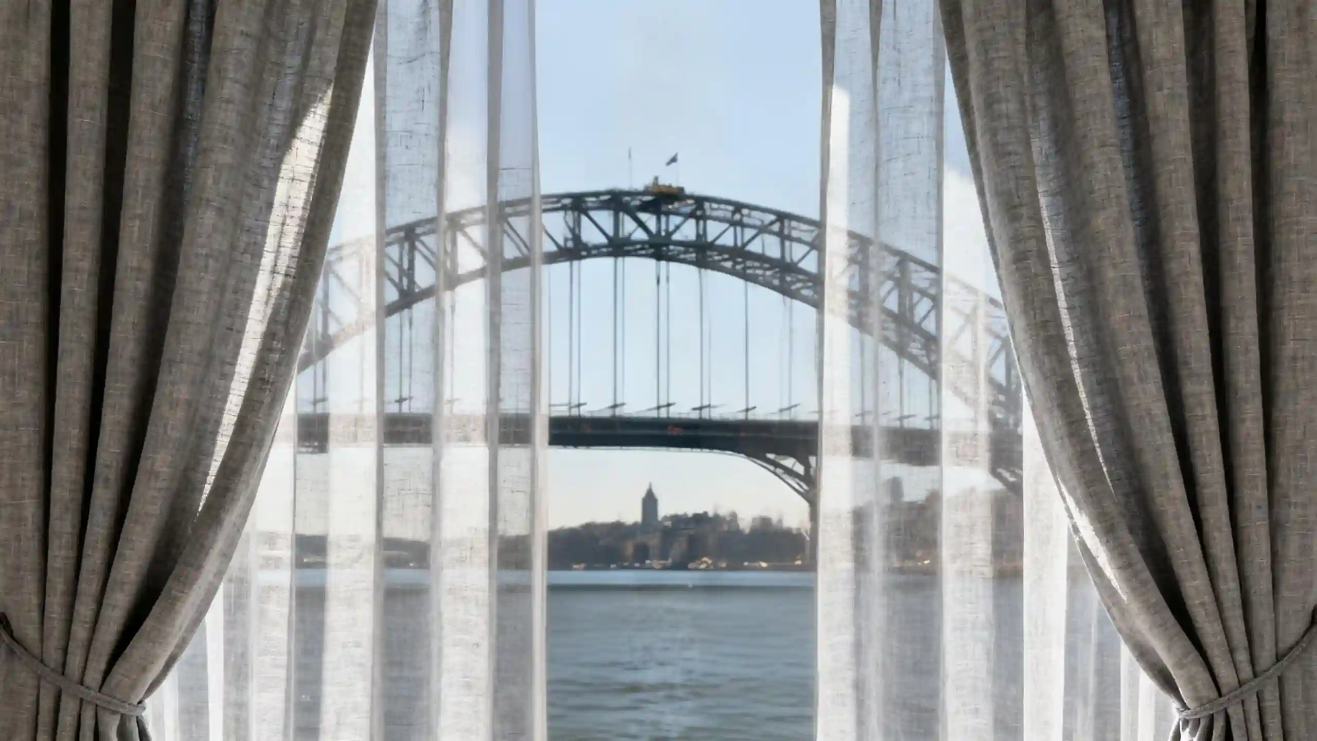 Sheer and lined curtains beside a coastal view