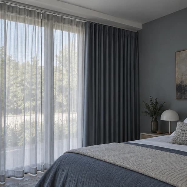 Illustrated separate sheer and blue-grey lined curtain layers in a bedroom; motor hardware is not visible