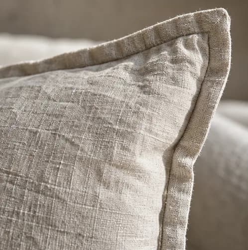 Washed linen cushion with a softly tailored flange edge