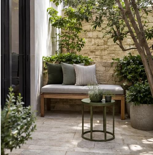 Compact courtyard bench with fitted outdoor cushions