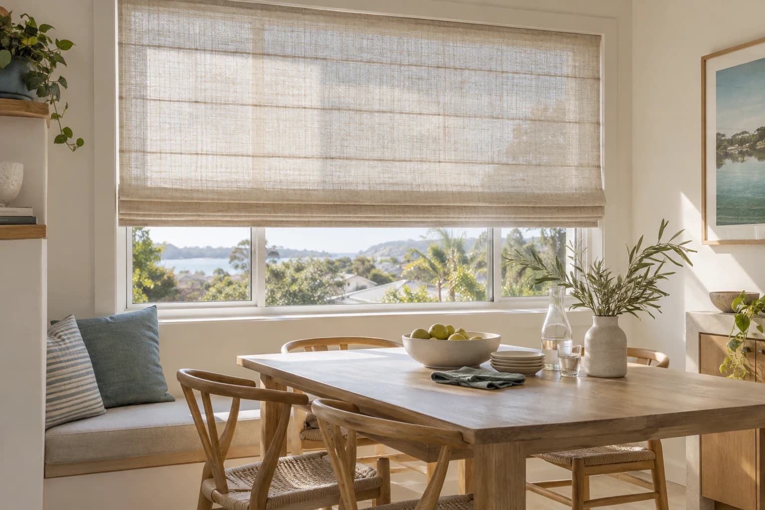 Translucent woven Roman blind filtering daylight in a coastal Sydney dining space.