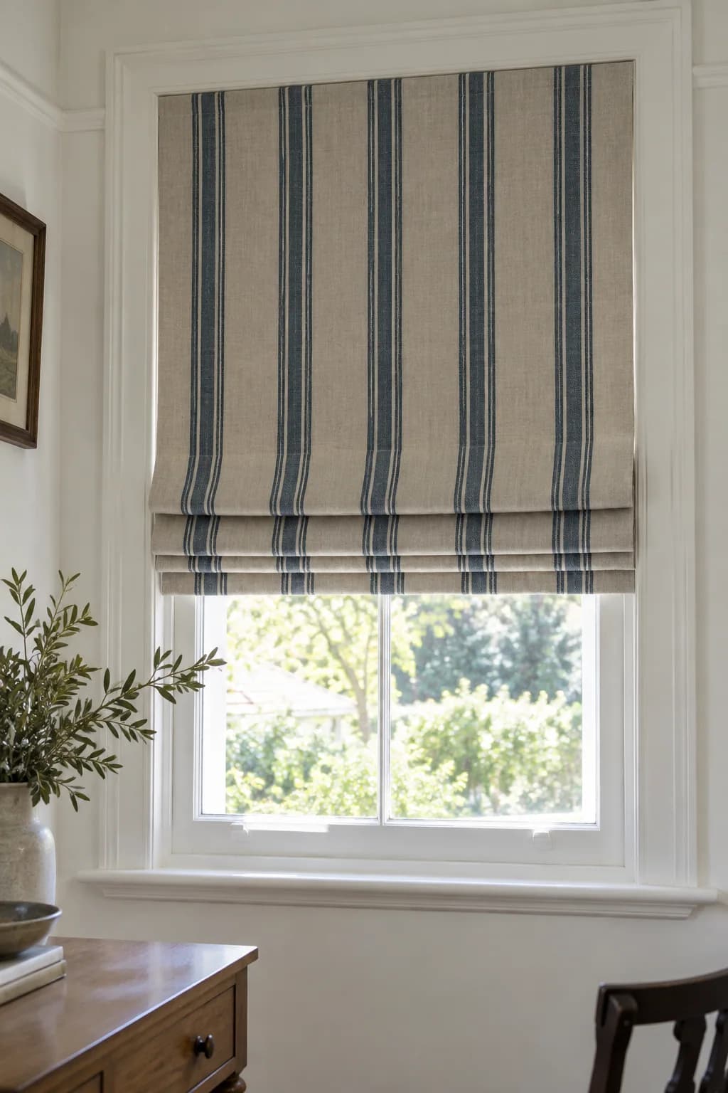 Striped decorative linen Roman blind with the pattern aligned through its folds