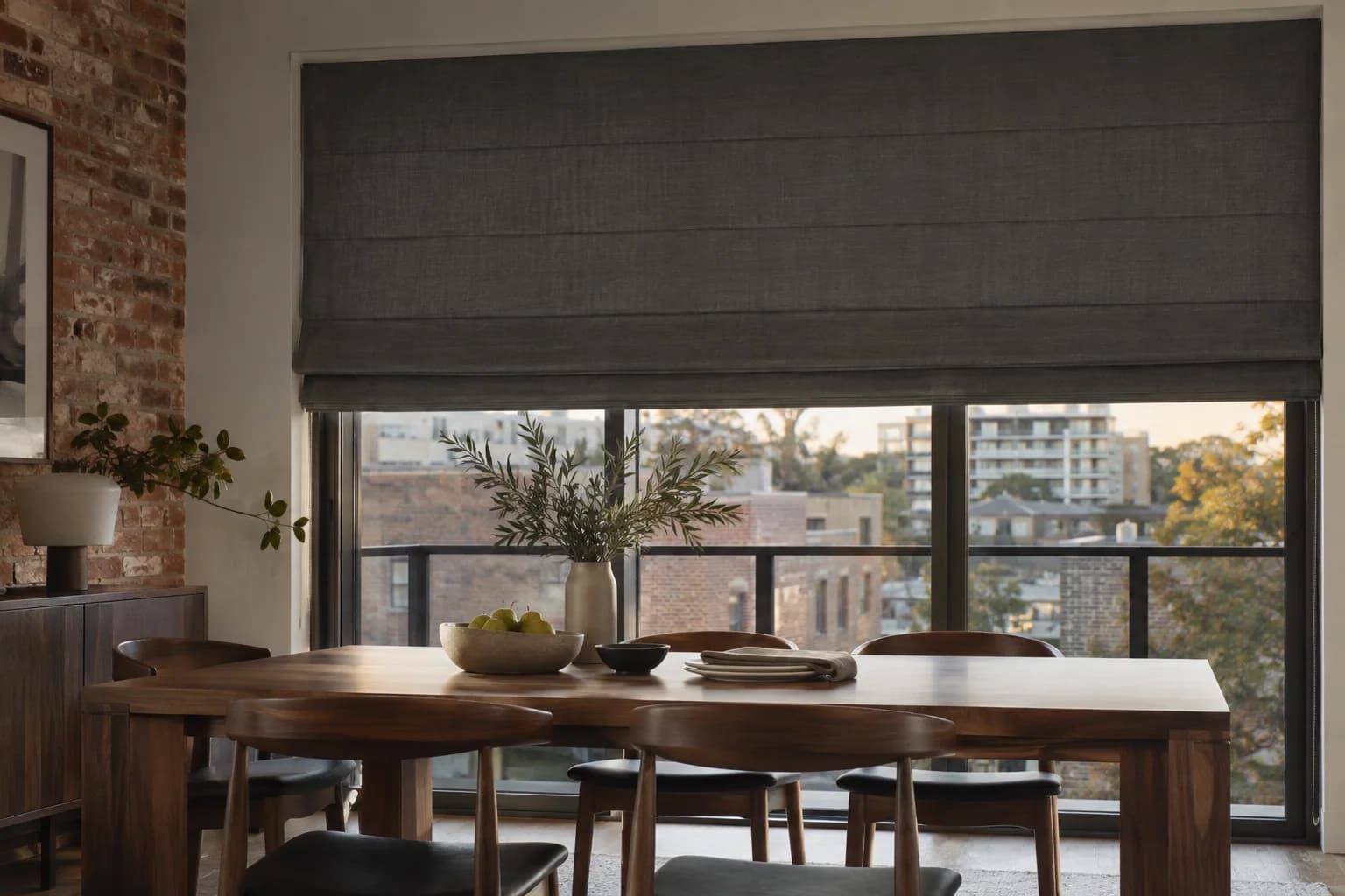 Charcoal linen Roman blind across a wide apartment window