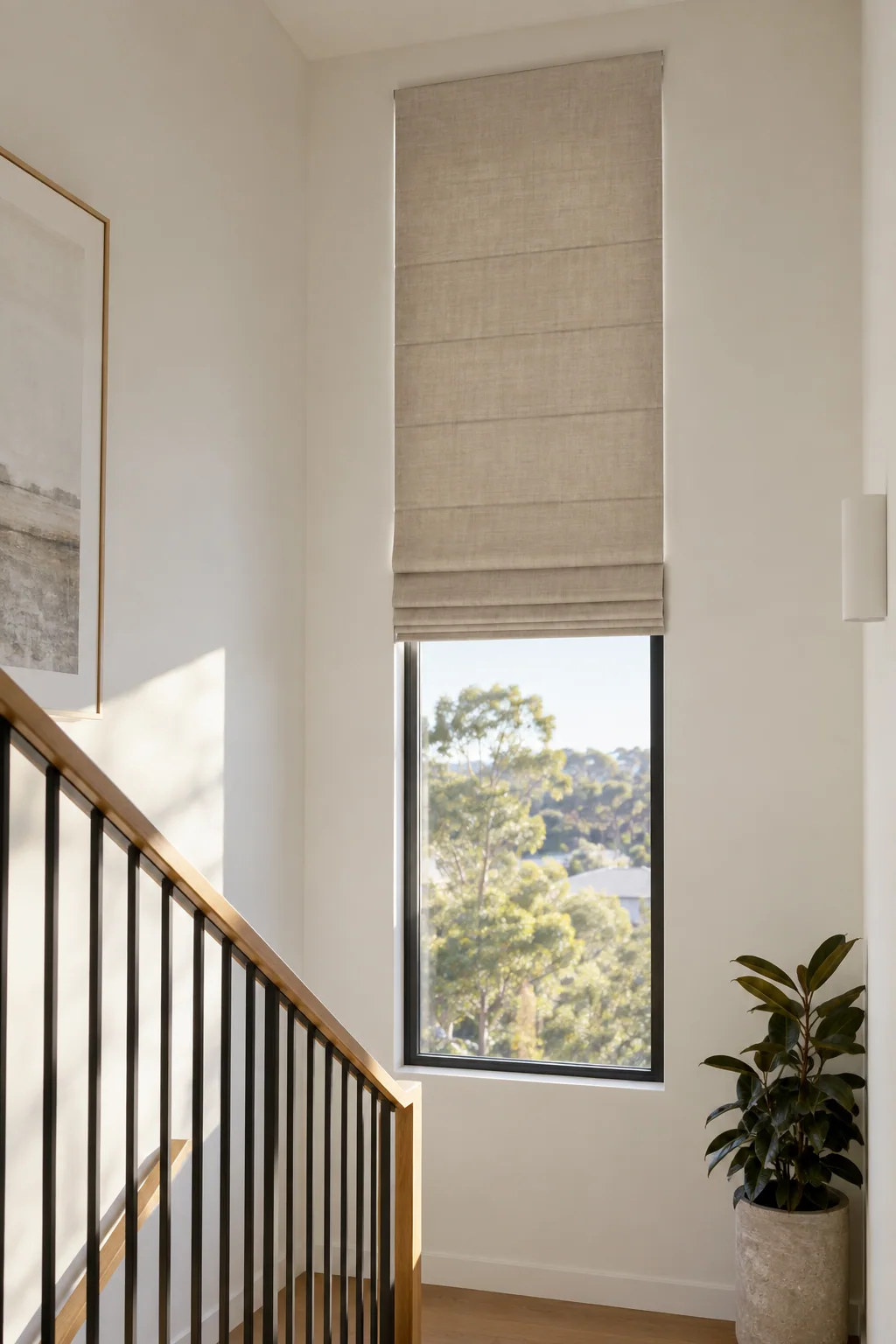 Tall motorised Roman blind above a stair landing in a contemporary Sydney home