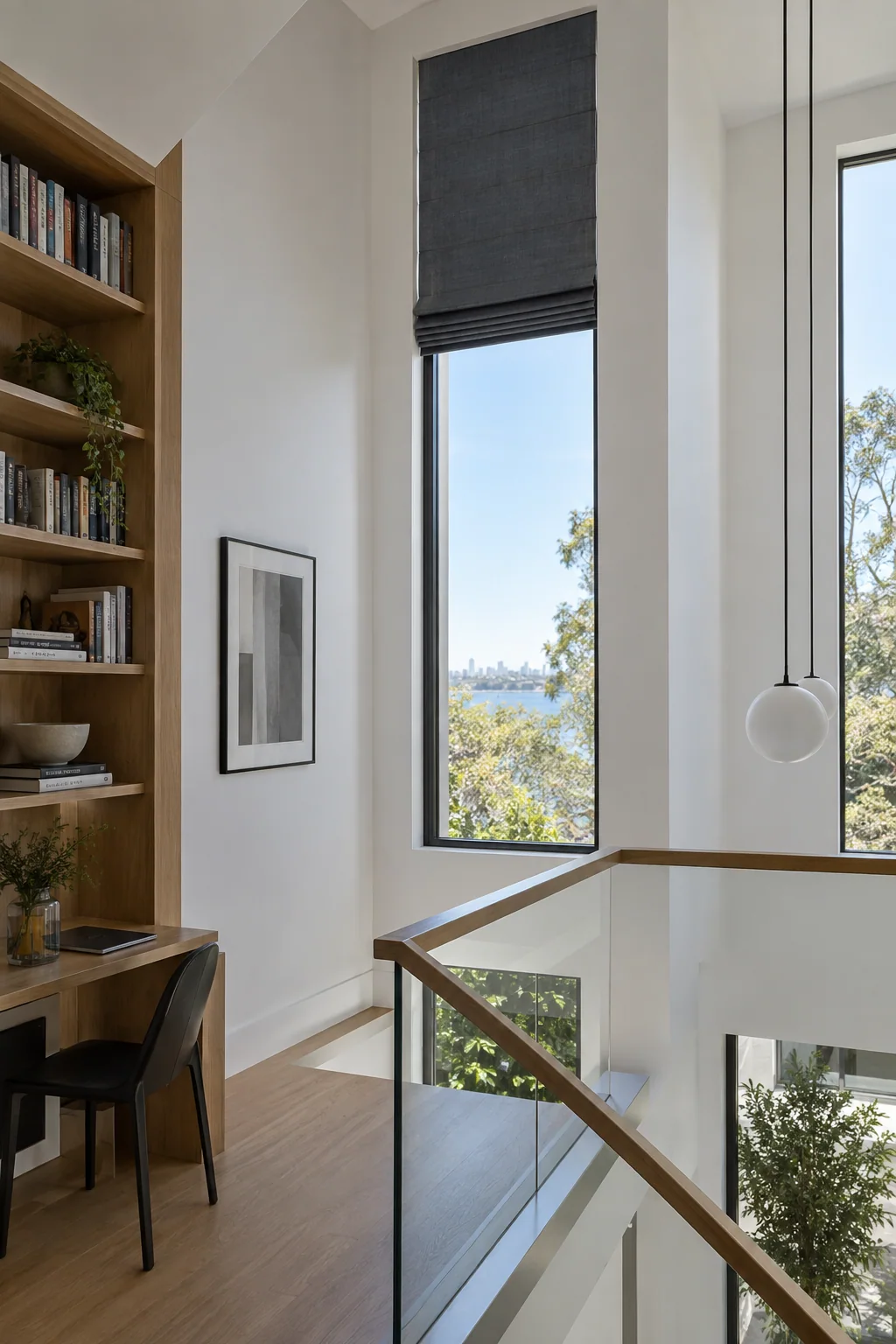 Tall motorised Roman blind at a high stair and study window