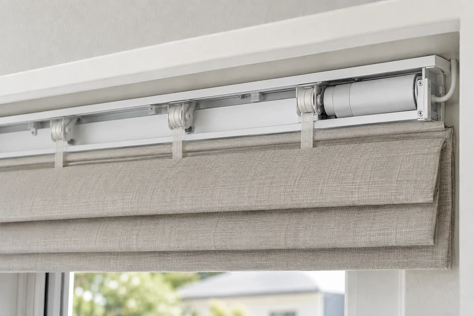 Close view of a Roman blind headrail, lifting mechanism and concealed motor