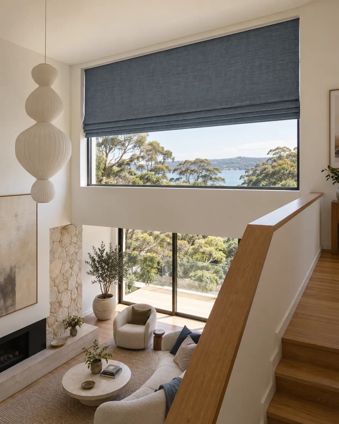 Roman blind installed high above a stair landing where direct manual access is limited