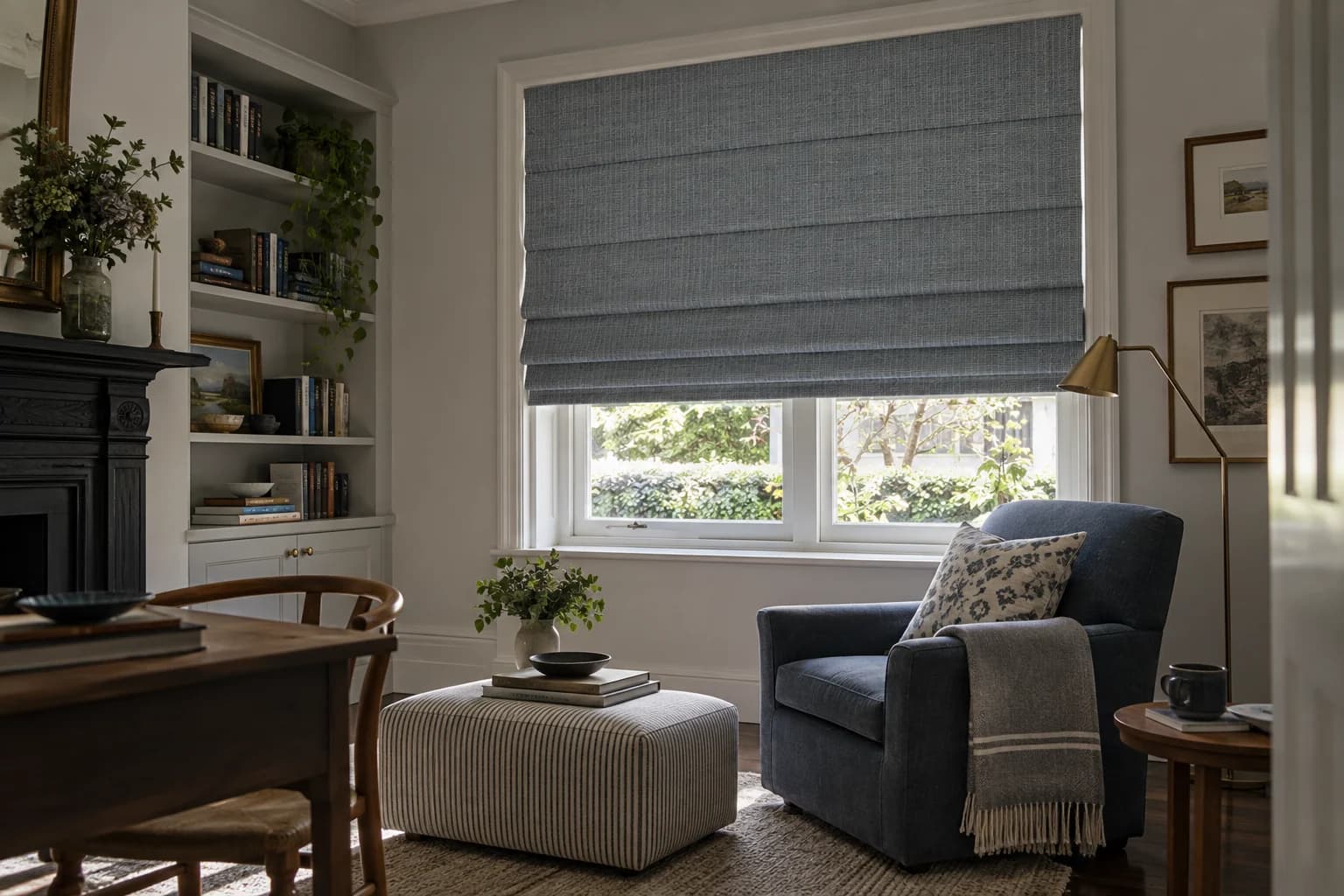 Blue-grey Waterfall Roman blind with repeated horizontal folds in a study