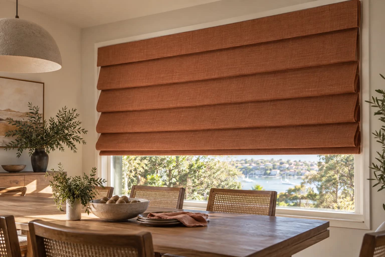 Rust Waterfall Roman blind with projecting folds in a Sydney dining room