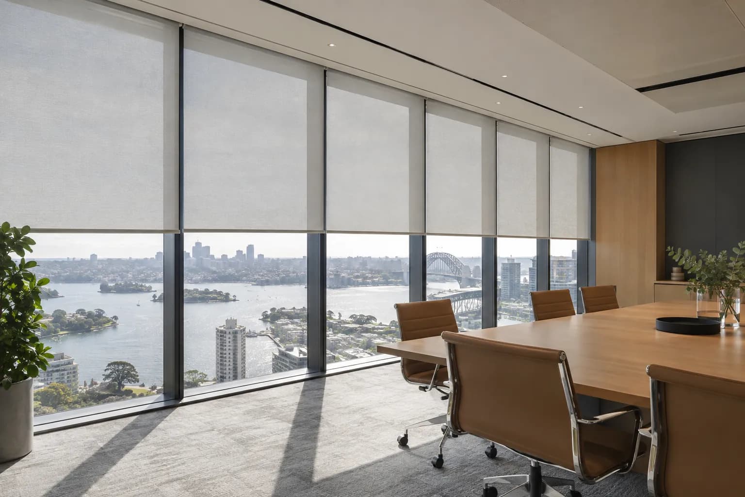 Commercial office with integrated roller blinds across broad glazing