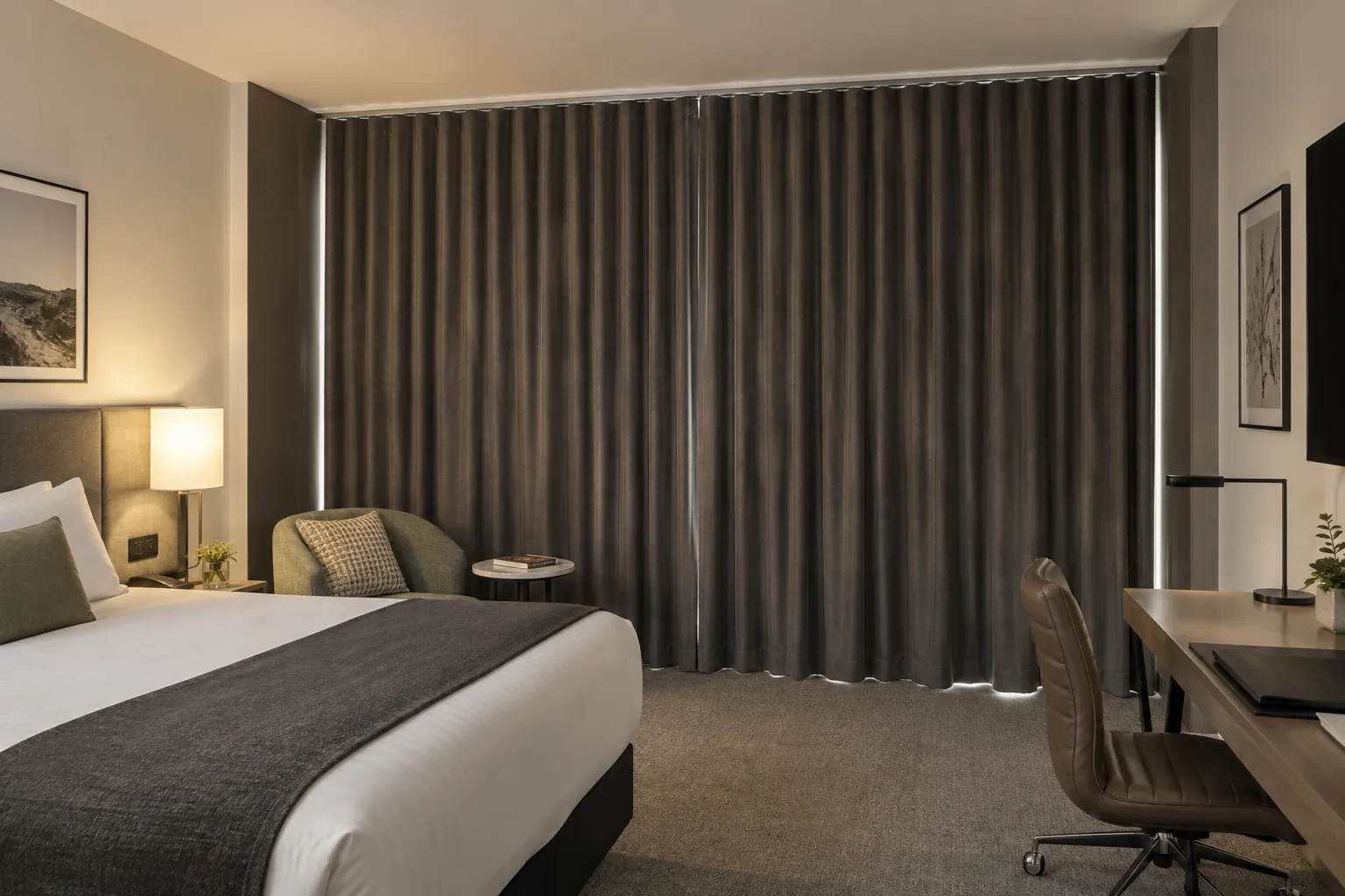 Hotel room with full-height blockout curtains and deep side returns
