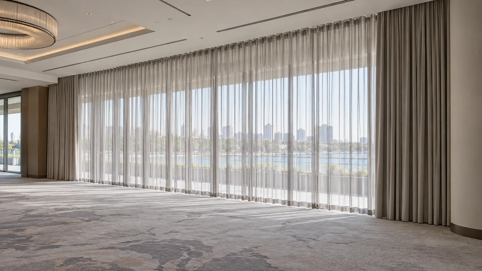 Full-height commercial curtain installation across a hospitality function space