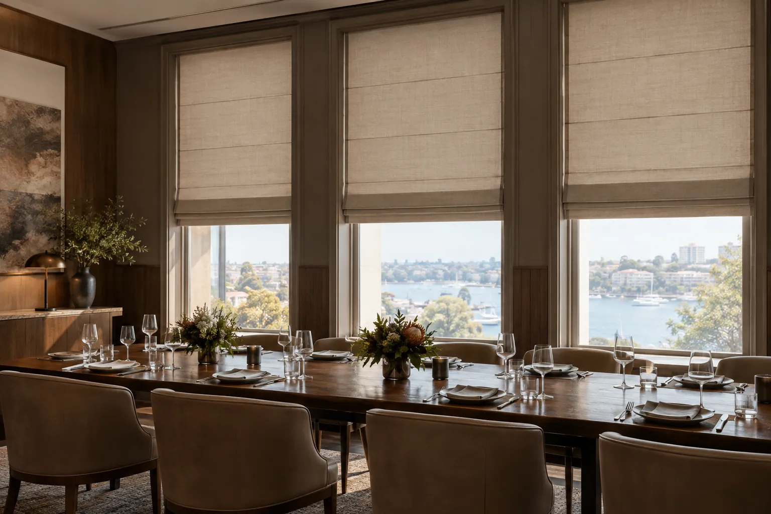 Three accurately aligned fabric Roman blinds across tall hospitality windows
