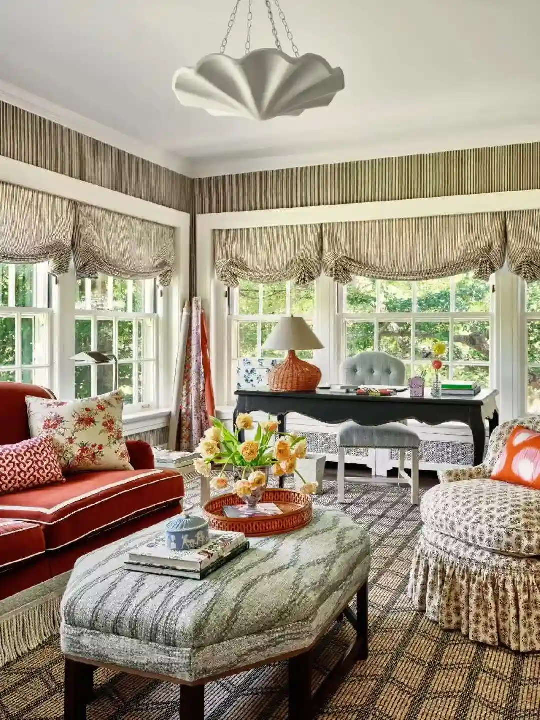 Layered decorative drapery arranged within a traditional interior