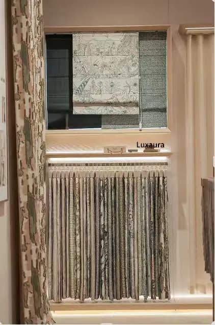 Hands arranging furnishing fabric during a workroom review