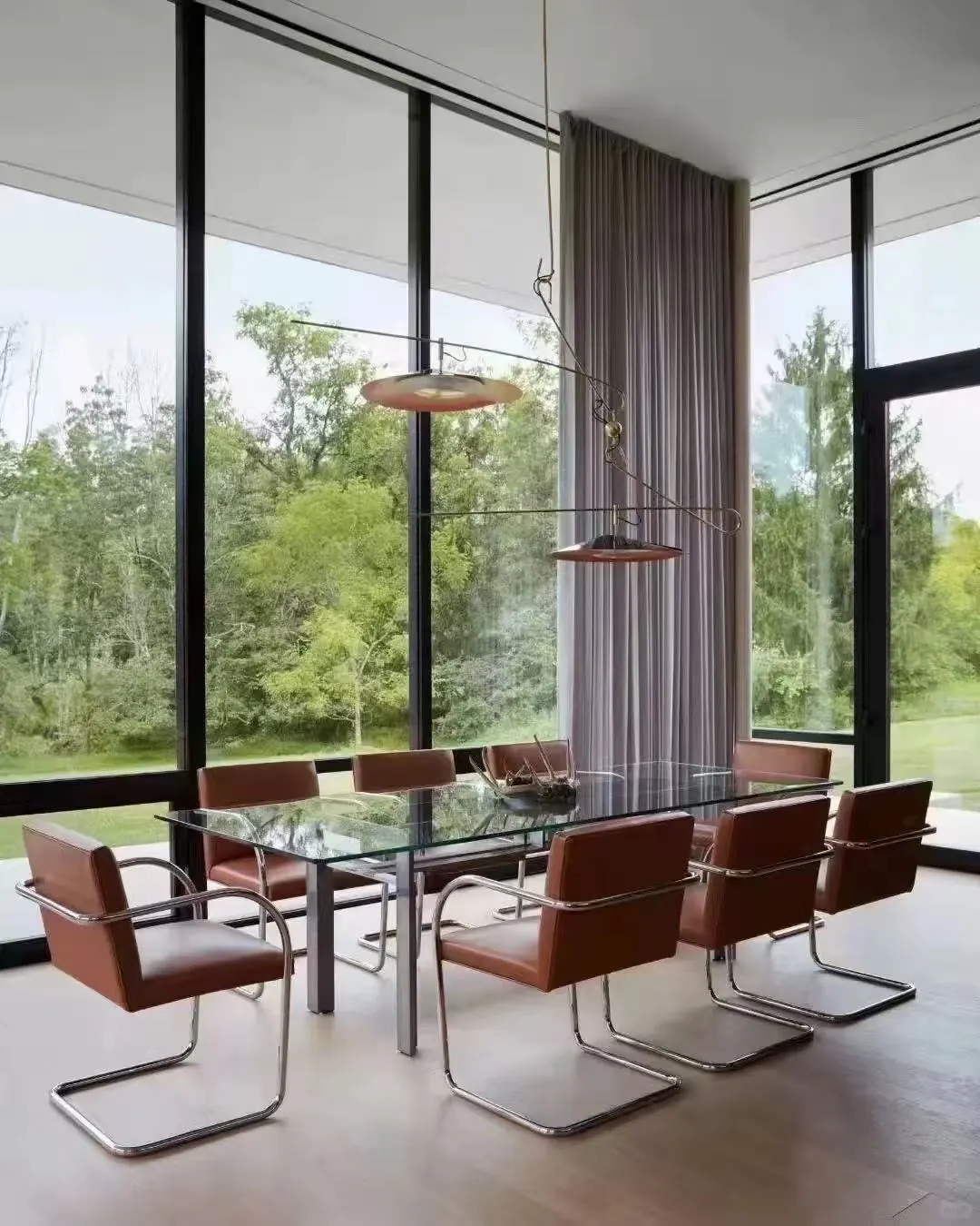 Open-plan dining area with a long curtain run integrated into the glazing