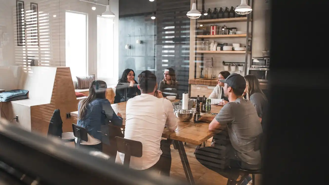 A team meeting around a project table in a contemporary workplace