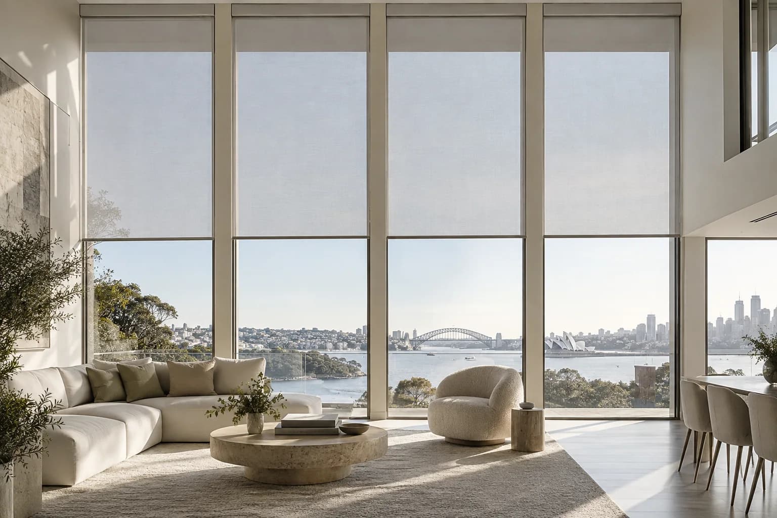 Aligned motorised roller blinds across double-height Sydney living-room glazing