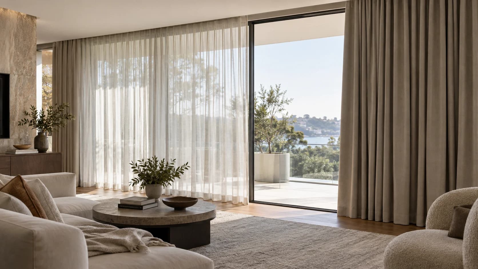 Wide living room showing an independent sheer layer and a separate blockout curtain partially drawn