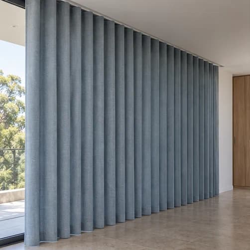 Side view of blue S-Fold curtains showing an even full-height fall and clean floor clearance