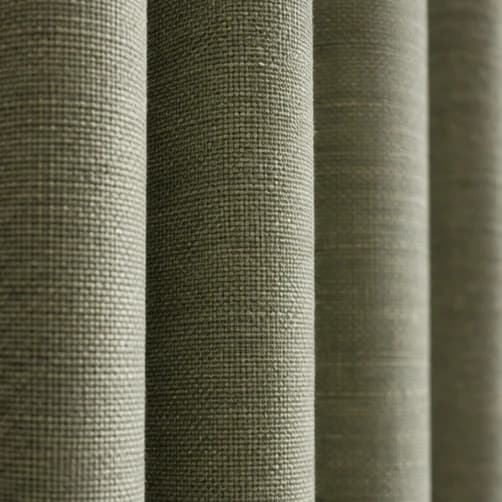 Grazing daylight revealing the weave and side profile of sage S-Fold fabric
