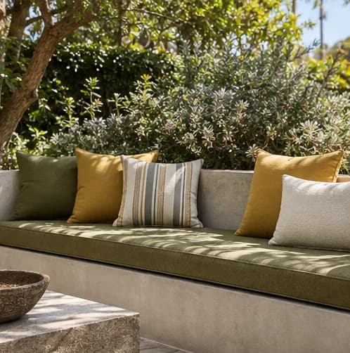 Built-in garden bench with fitted green and ochre cushions
