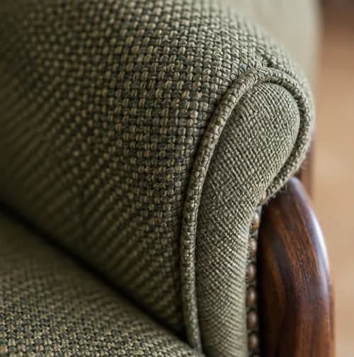 Close view of piping and upholstery tension on an armchair