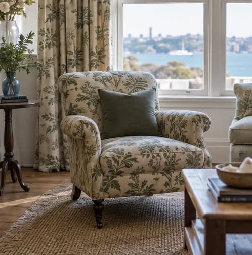 Reupholstered patterned armchair coordinated with curtains in a finished room