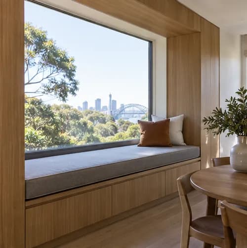 Long window-seat cushion fitted into contemporary timber joinery