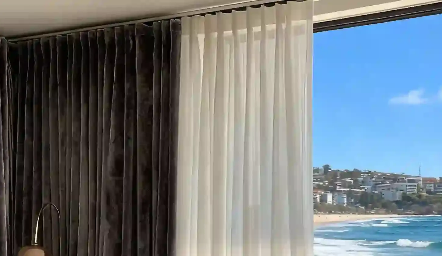 Full-height layered curtains finished closely beneath the ceiling