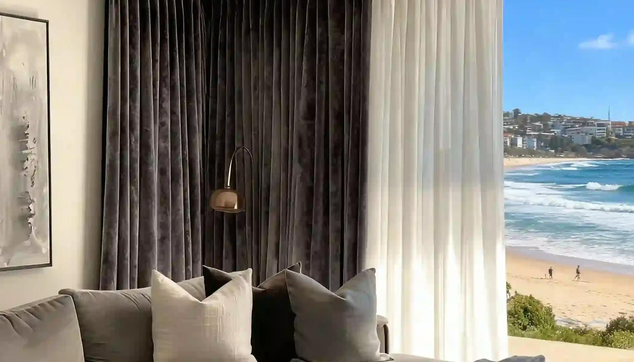 Independent sheer and dark lined curtains arranged together at a wide window