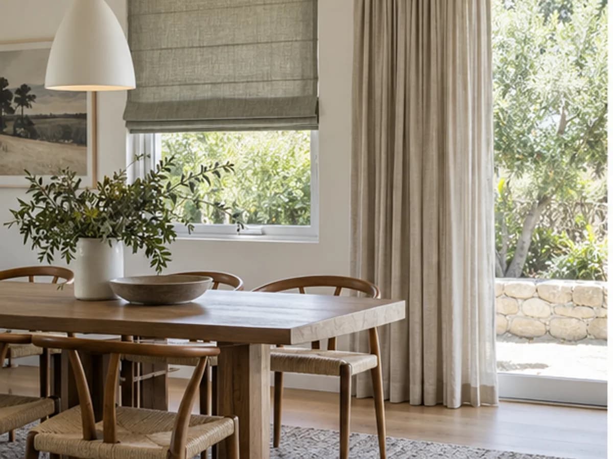A Roman blind and full curtains used on different openings within one coordinated dining room