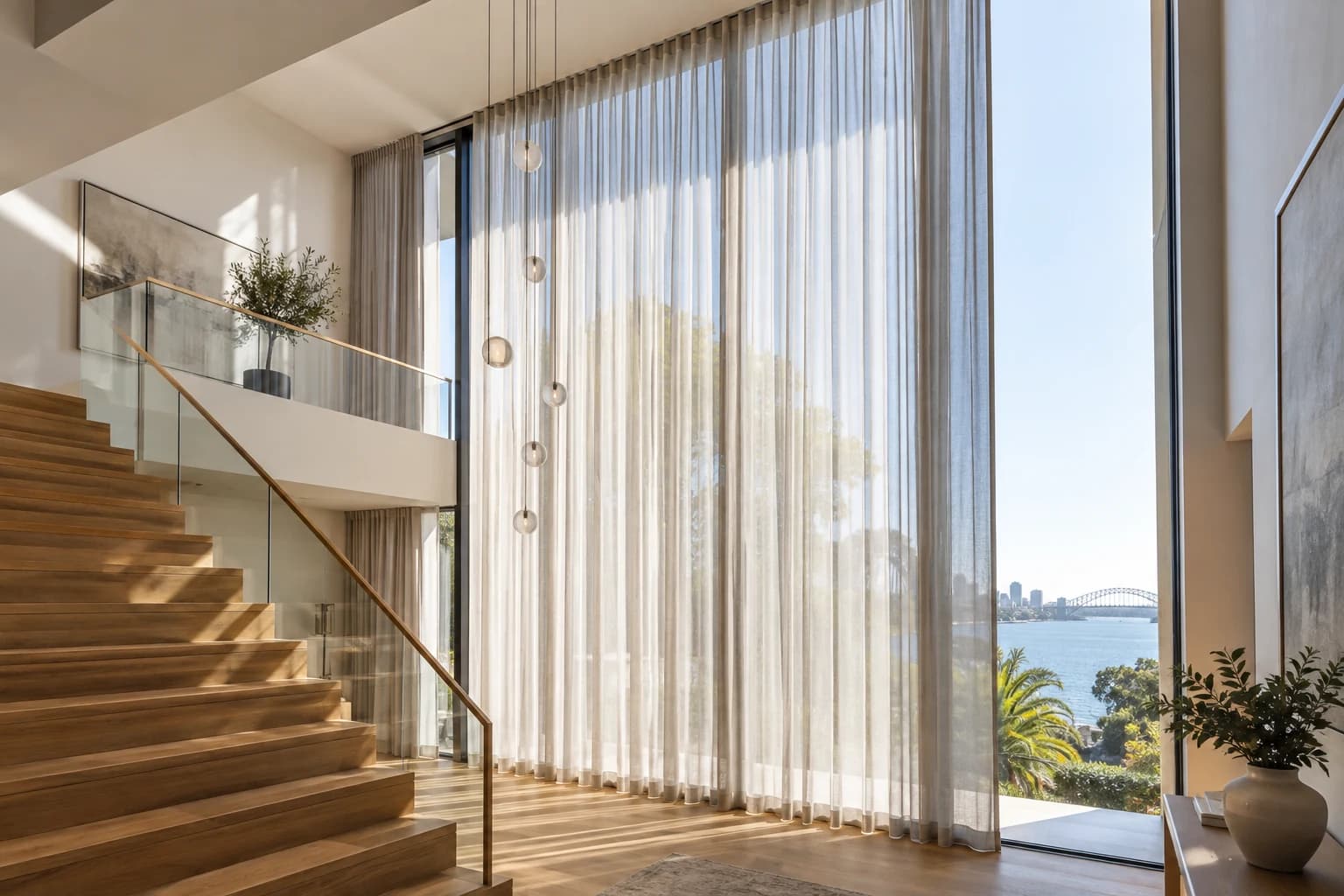 Full-height motorised curtain treatment planned around tall architectural glazing