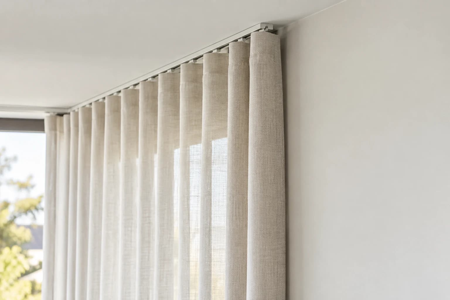 Finished curtain folds meeting their track with an even return at the wall