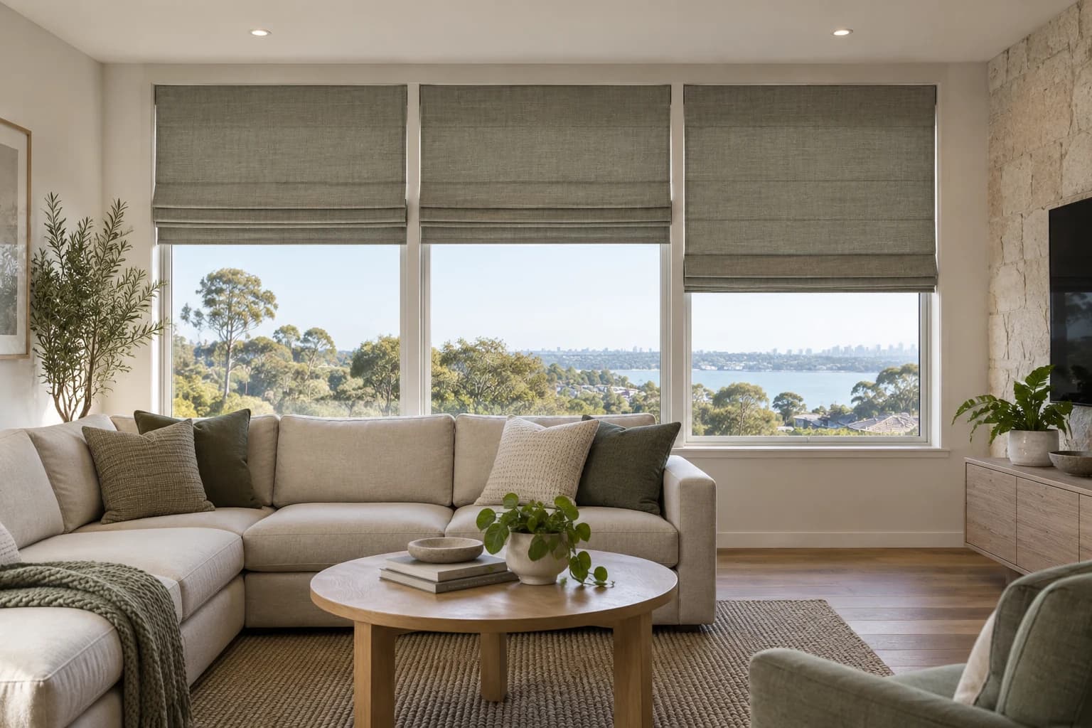 Three coordinated Roman blinds across wide living-room glazing